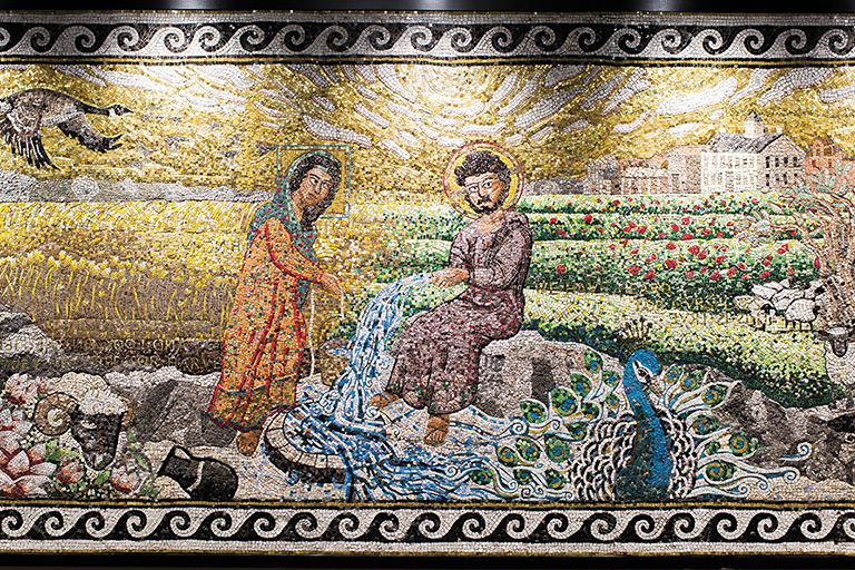This mosaic—which was commissioned by the President’s
Art Commission—was designed by Professor
Jeremy Botts and constructed by students under
the direction of Professor Leah Samuelson. The
piece depicts the encounter between a Samaritan
woman and Jesus at Jacob’s well. The work is displayed
at the entryway to Barrows Auditorium in
Billy Graham Hall, and it embodies all disciplines
studied in the Wheaton College Graduate School.
Made with over 63,000 hand-cut tesserae (including
pieces donated by the Department of Geology,
faculty, staff , and alumni), the mosaic incorporates
visual elements from ancient and classical western
eras, early Christian art under the rule of Justinian,
the Italian Renaissance, West Bank landscape, Midwest
America landscape, Mennonite symbols, and
recognizable places on Wheaton’s campus.