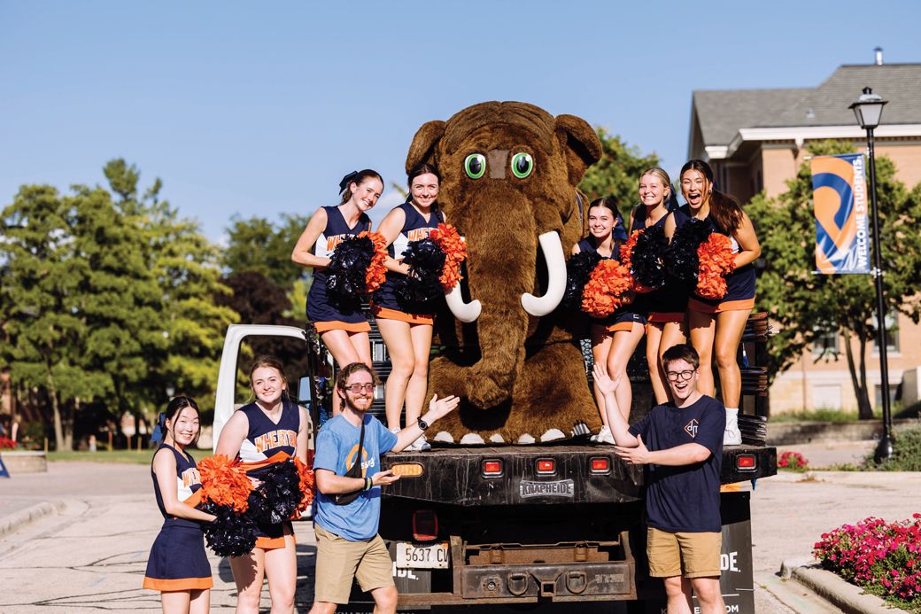 The Wheaton College Thunder mascot, Tor, hangs out with the cheer squad. 