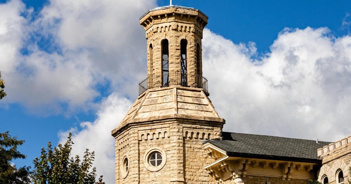 Blanchard Hall bell tower against a blue sky with clouds
