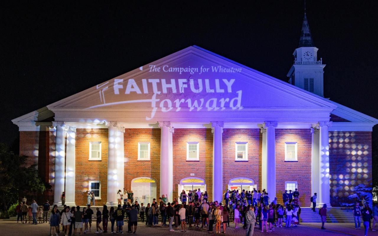 Projectors light up Edman Chapel with Wheaton colors and Faithfully Forward signage.