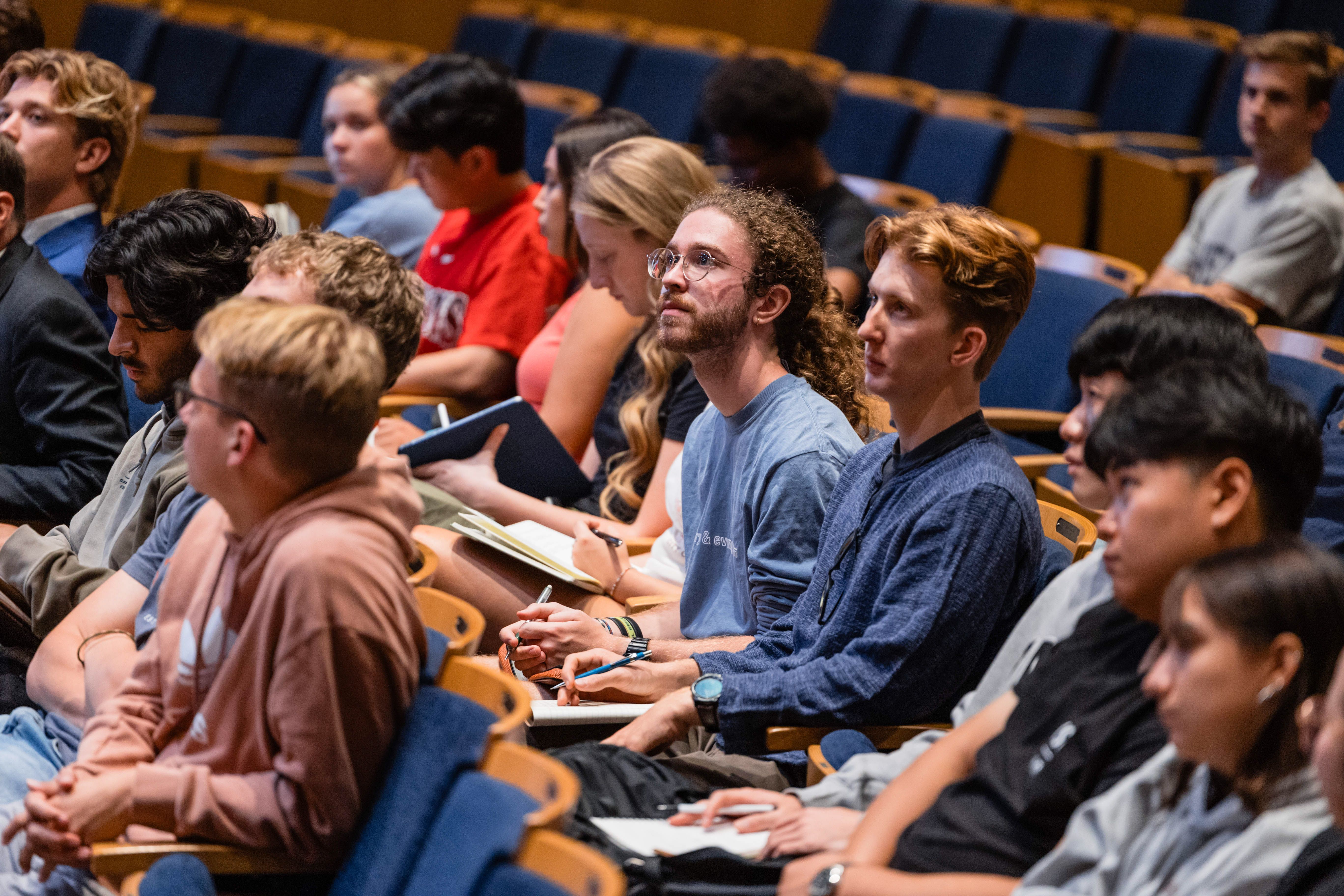 Students take notes during a lecture designed to prepare them to lead clubs and organizations for the school year.