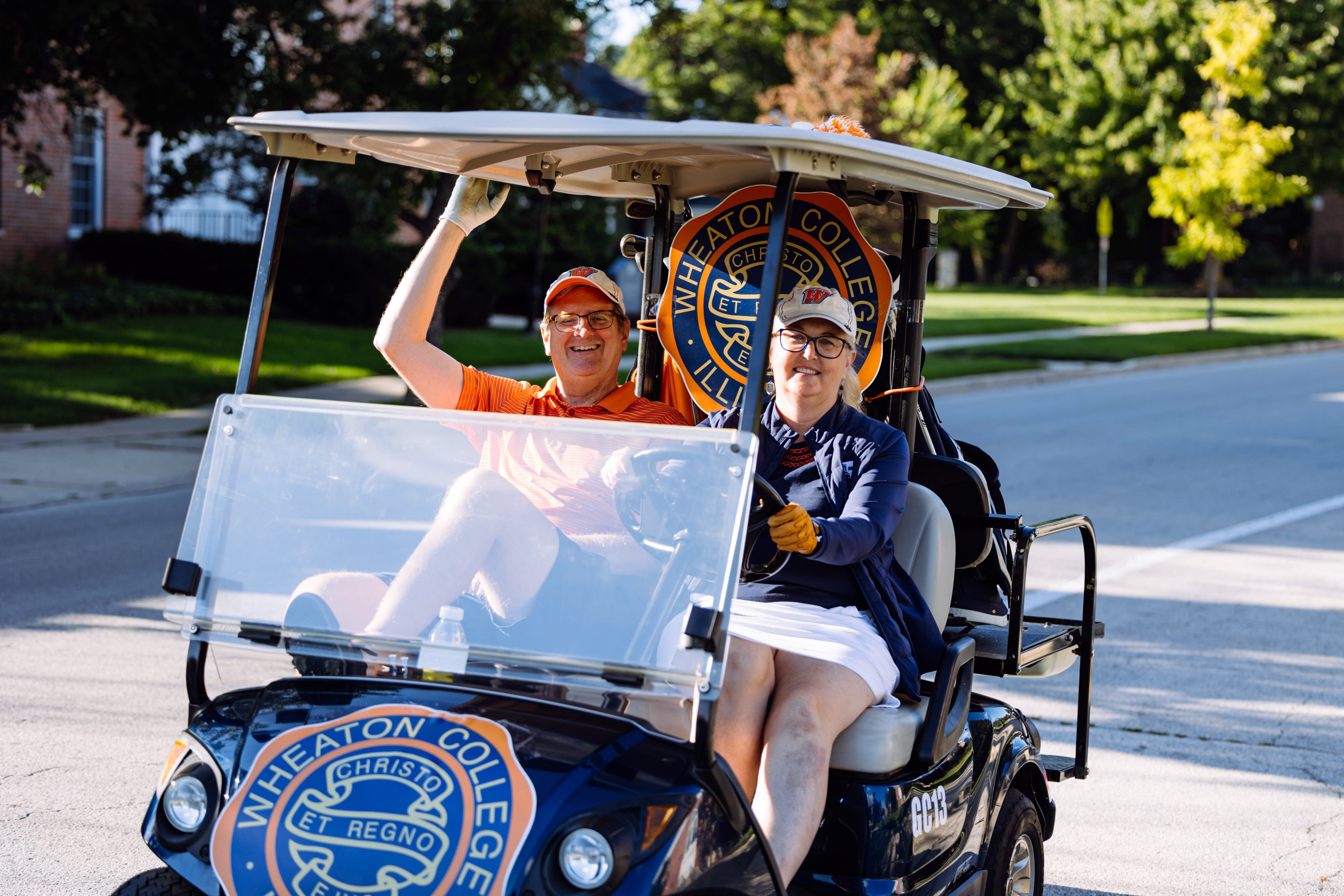 President Philip Ryken ’88 and his wife, Lisa ’88, greet students from a golf cart on campus.