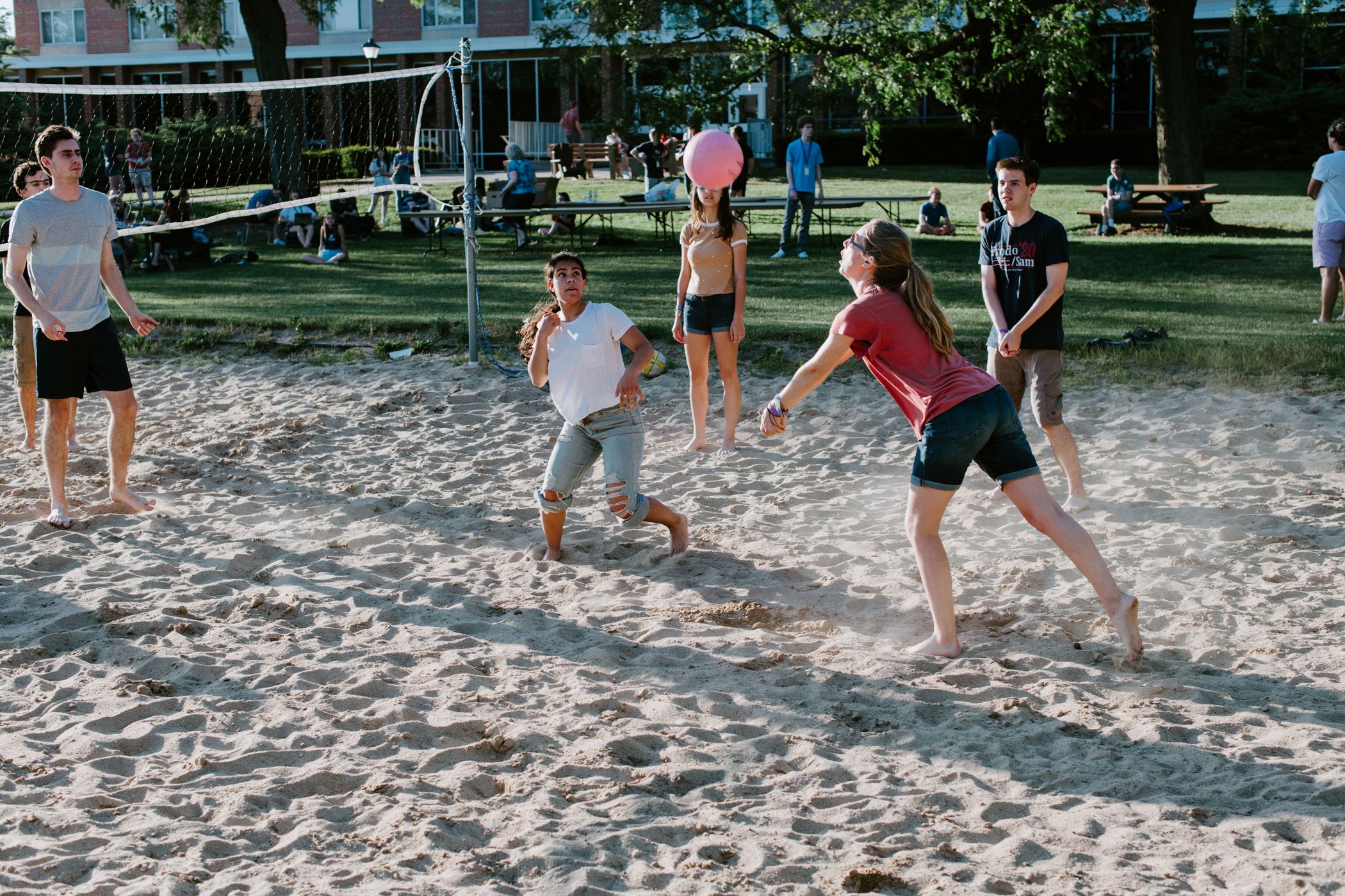 Wheaton College Summer Institute Students playing volleyball on campus