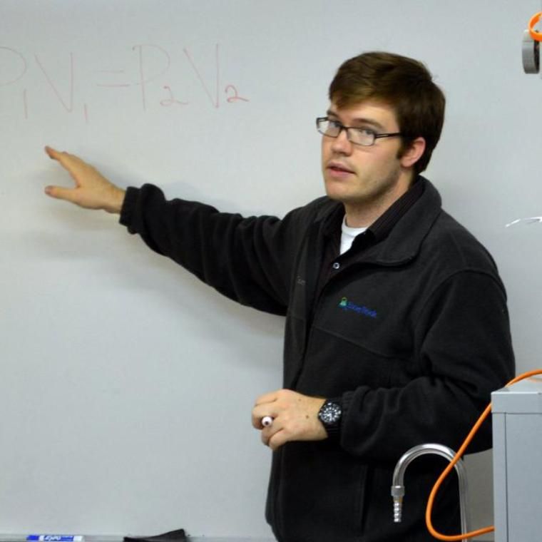 teacher at white board teaching math