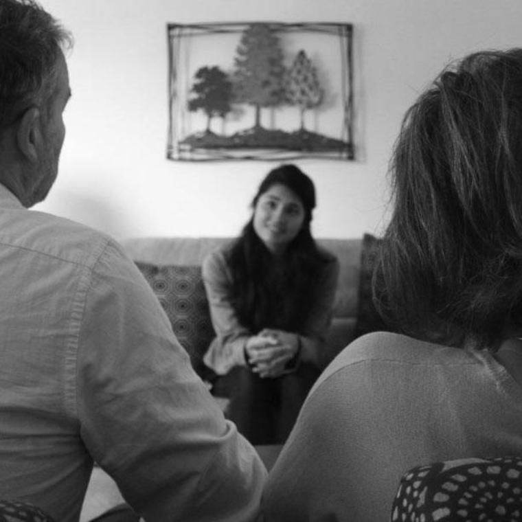 A woman counseling a married couple