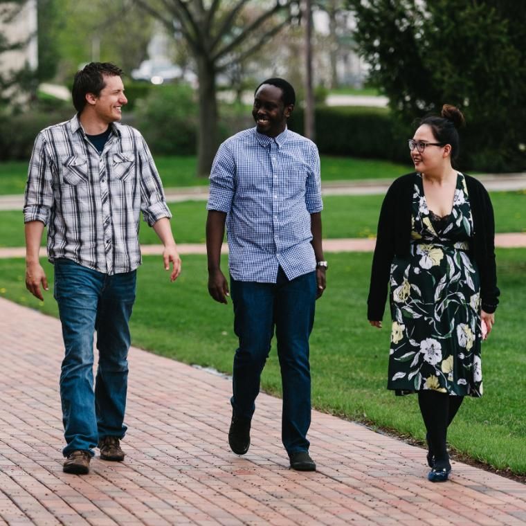 Four Wheaton College Graduate School students walking together