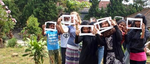 HNGR student with children and signs