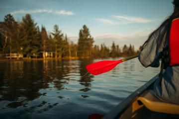 Vanguard paddling down long lake at HoneyRock in Three Lakes, WI