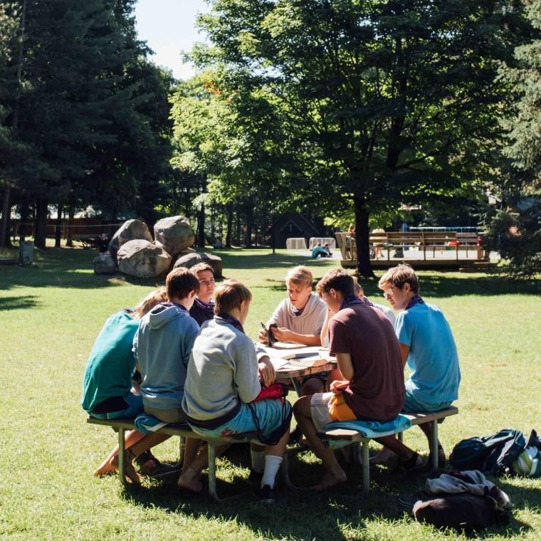 high schoolers talking at a table