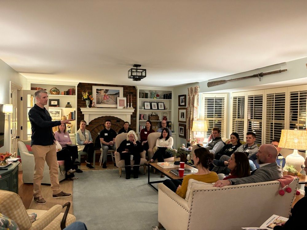 A group of camper families gathered in a living room