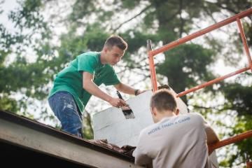 painting exterior wall at HoneyRock in Three Lakes WI