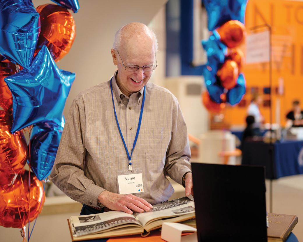 Verne Evans ’59 flips through old yearbook photos.