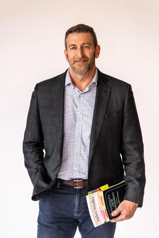 Wheaton College English professor holding books