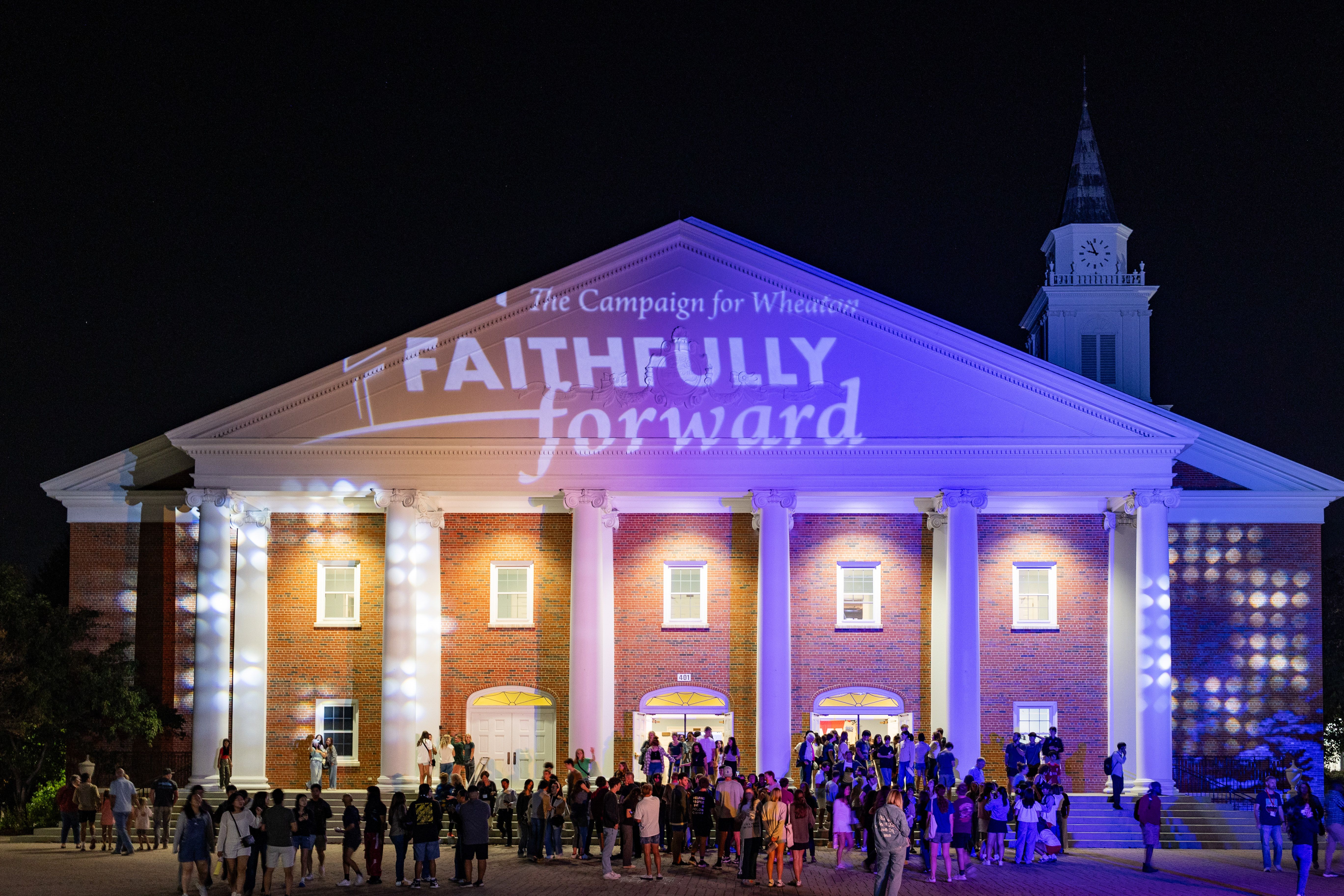 Projectors light up Edman Chapel with Wheaton colors and Faithfully Forward signage.