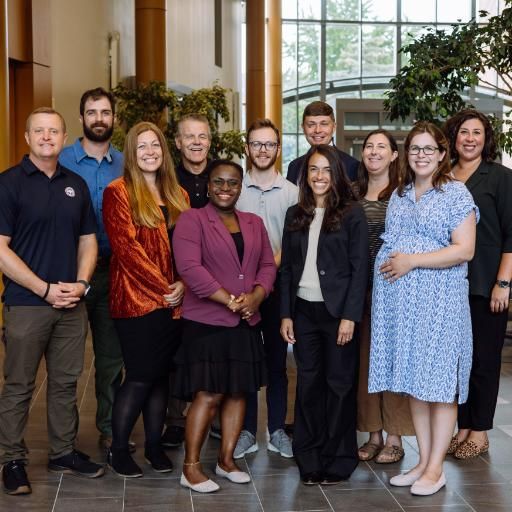 Eleven Wheaton College faculty stand in two rows