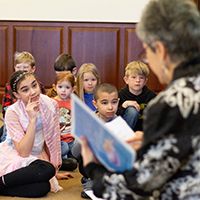 A lady reading to some children